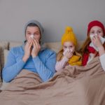 Sick family sitting on couch.