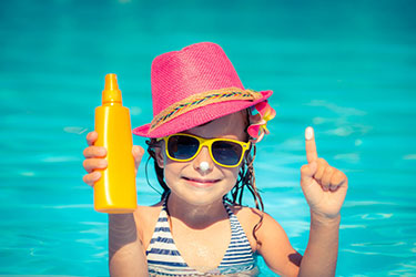 little girl in pool with sunscreen