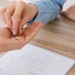 Health Professional Handing Pills to Patient