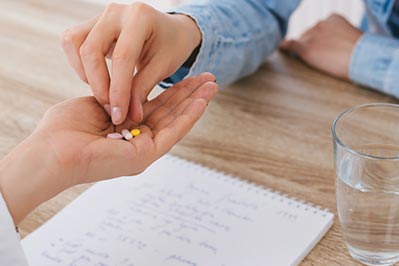 Health Professional Handing Pills to Patient