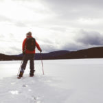 Snowshoeing on a Lake with Mountains