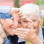 Elderly Woman Smiling with Caregiver