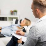 Hypnotherapist with Woman Laying on Couch