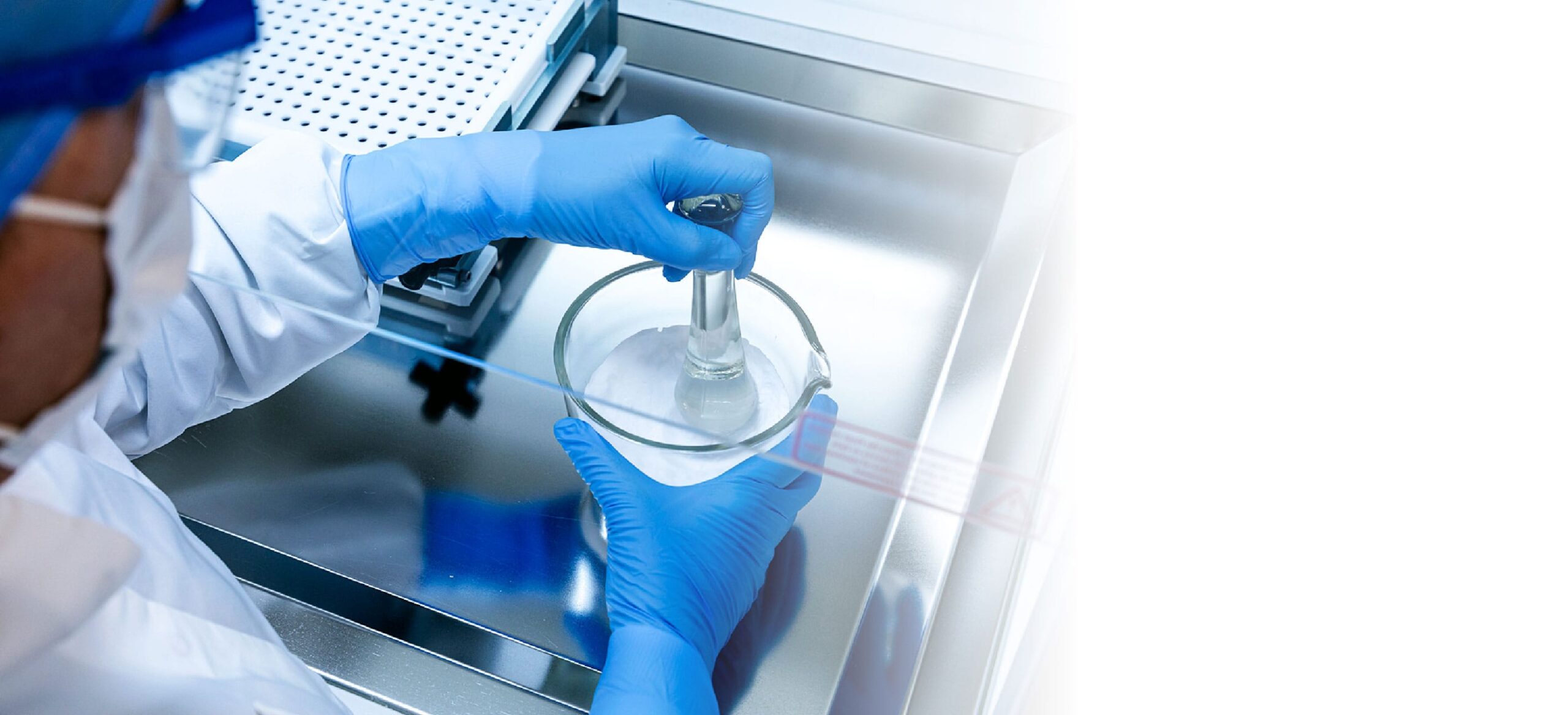 Pharmaceutical compounding: a technician preparing medication in a sterile environment.