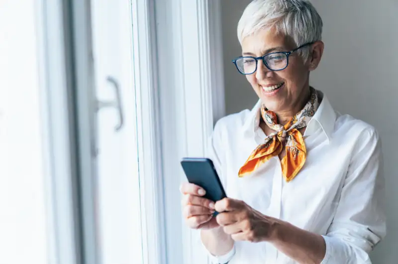Smiling Woman Looking at Phone