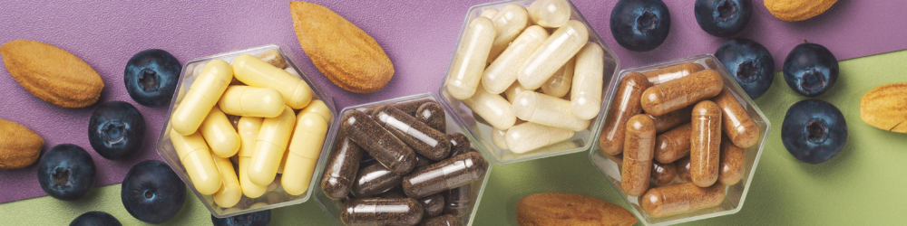 Supplements and fresh produce arranged on a clean counter, illustrating how to choose the right multivitamin
